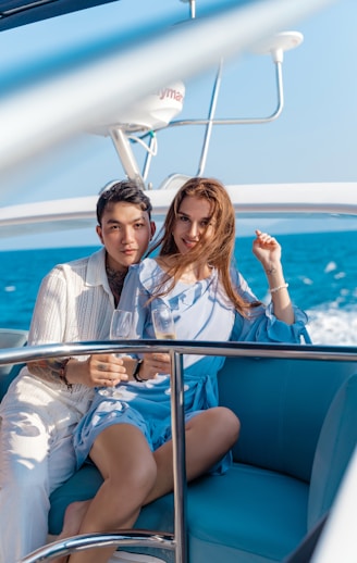 a man and a woman sitting on a boat
