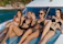 a group of women sitting on top of a boat