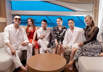 a group of people sitting on a couch next to each other