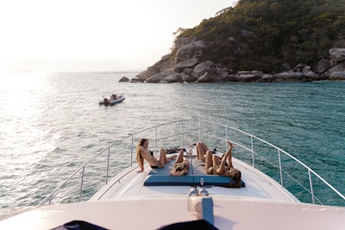 a group of people lounging on the back of a boat
