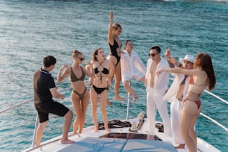 a group of people standing on a boat in the water