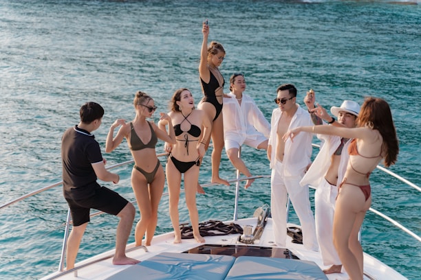 a group of people standing on a boat in the water