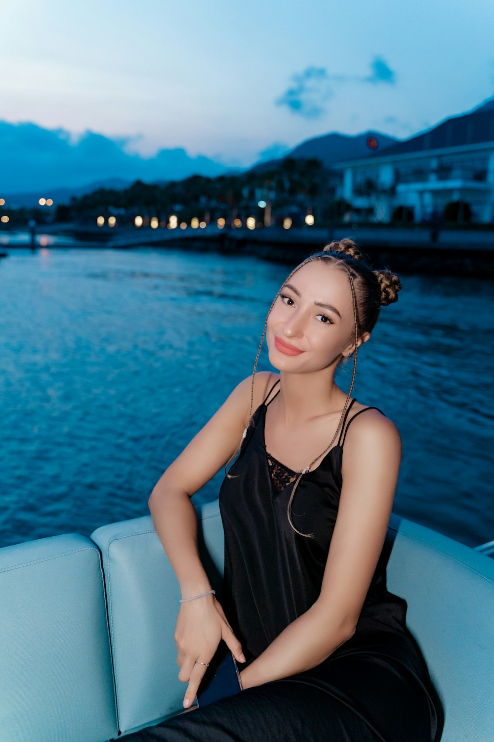 a woman sitting on a boat in the water