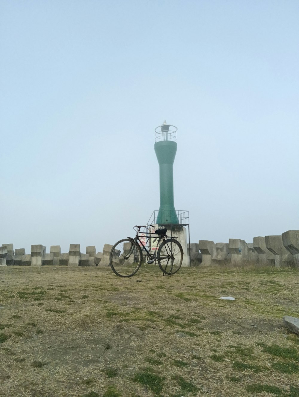 a bicycle parked in front of a green tower