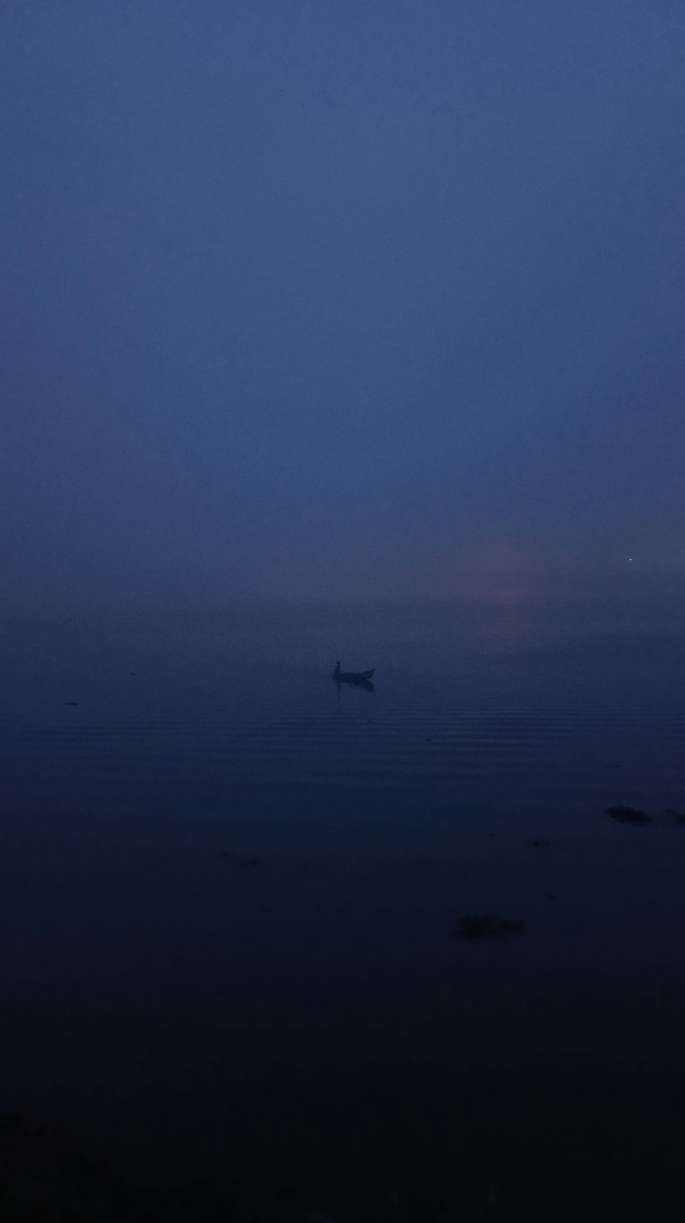 a boat floating on top of a large body of water