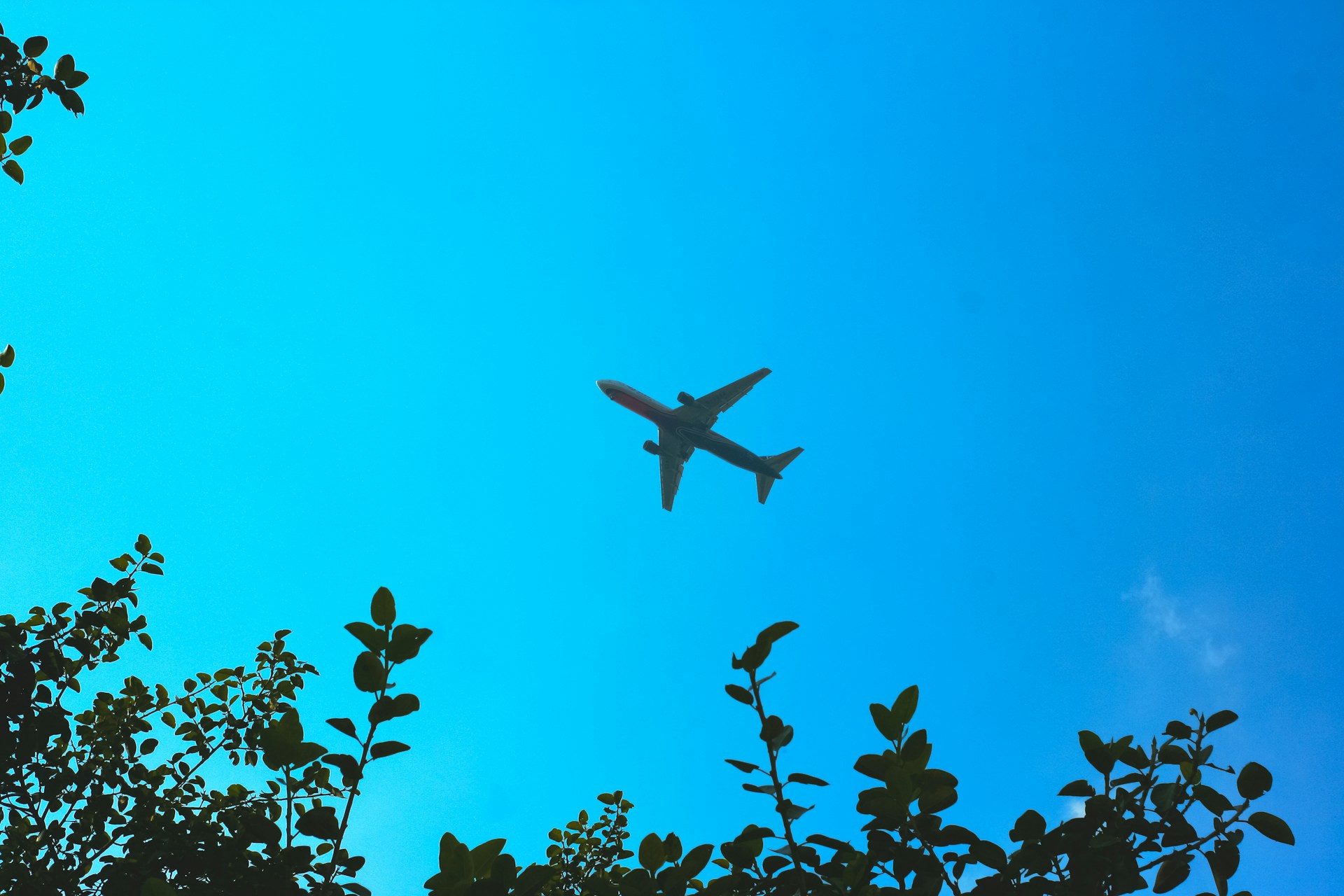 an airplane is flying through the blue sky