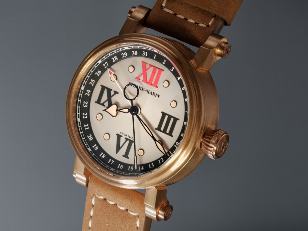 a close up of a wrist watch with a brown strap