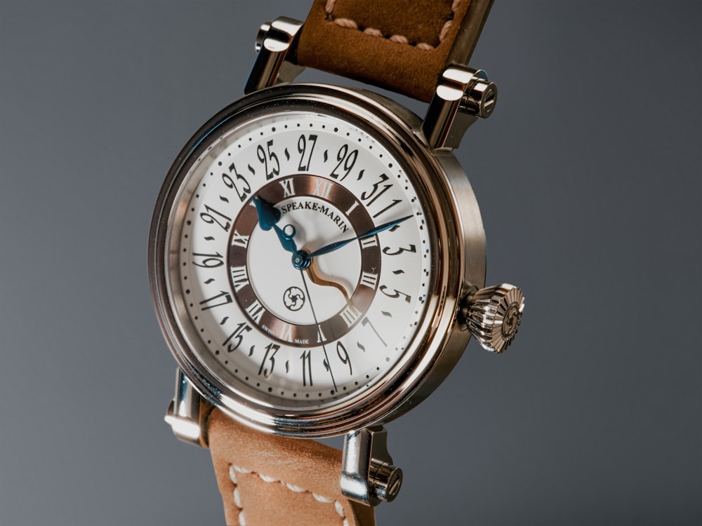 a close up of a wrist watch with a brown strap