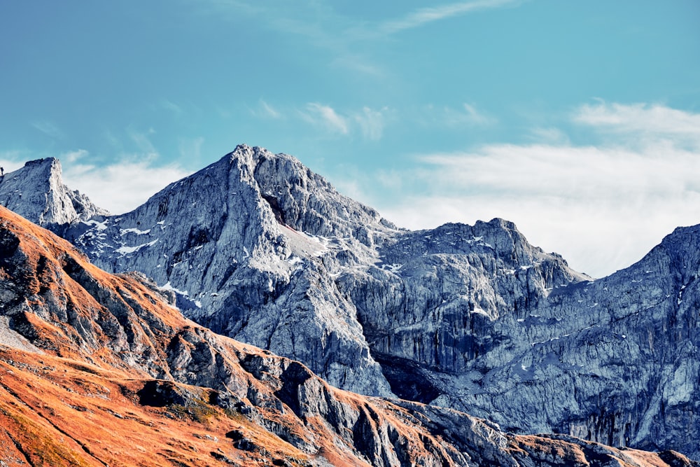 a view of a mountain range with a blue sky in the background