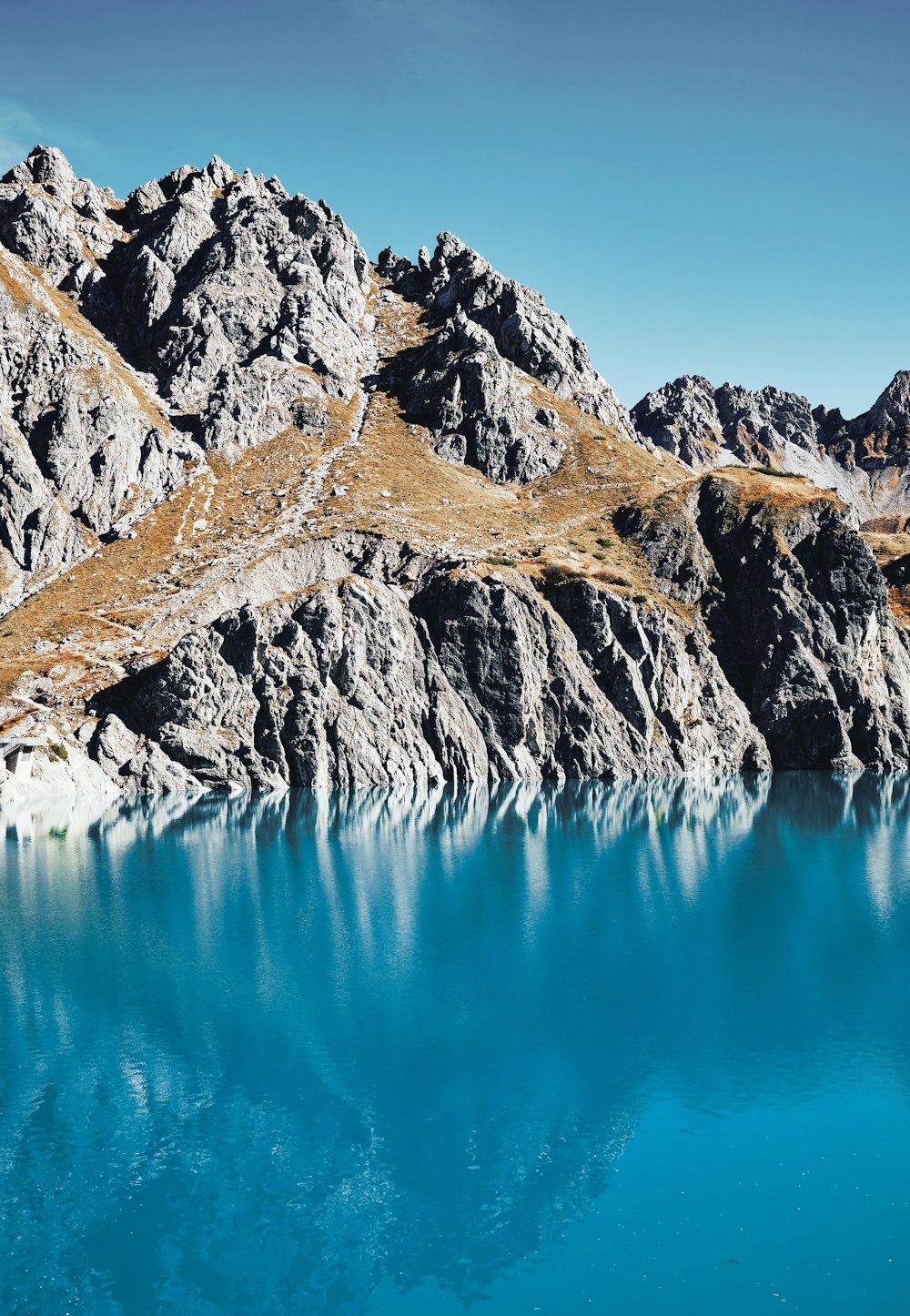 a mountain range with a lake in the foreground