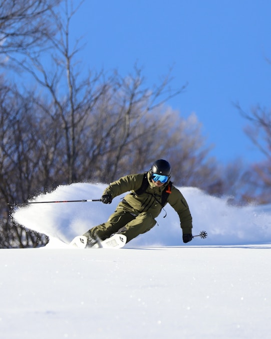 a man riding skis down a snow covered slope