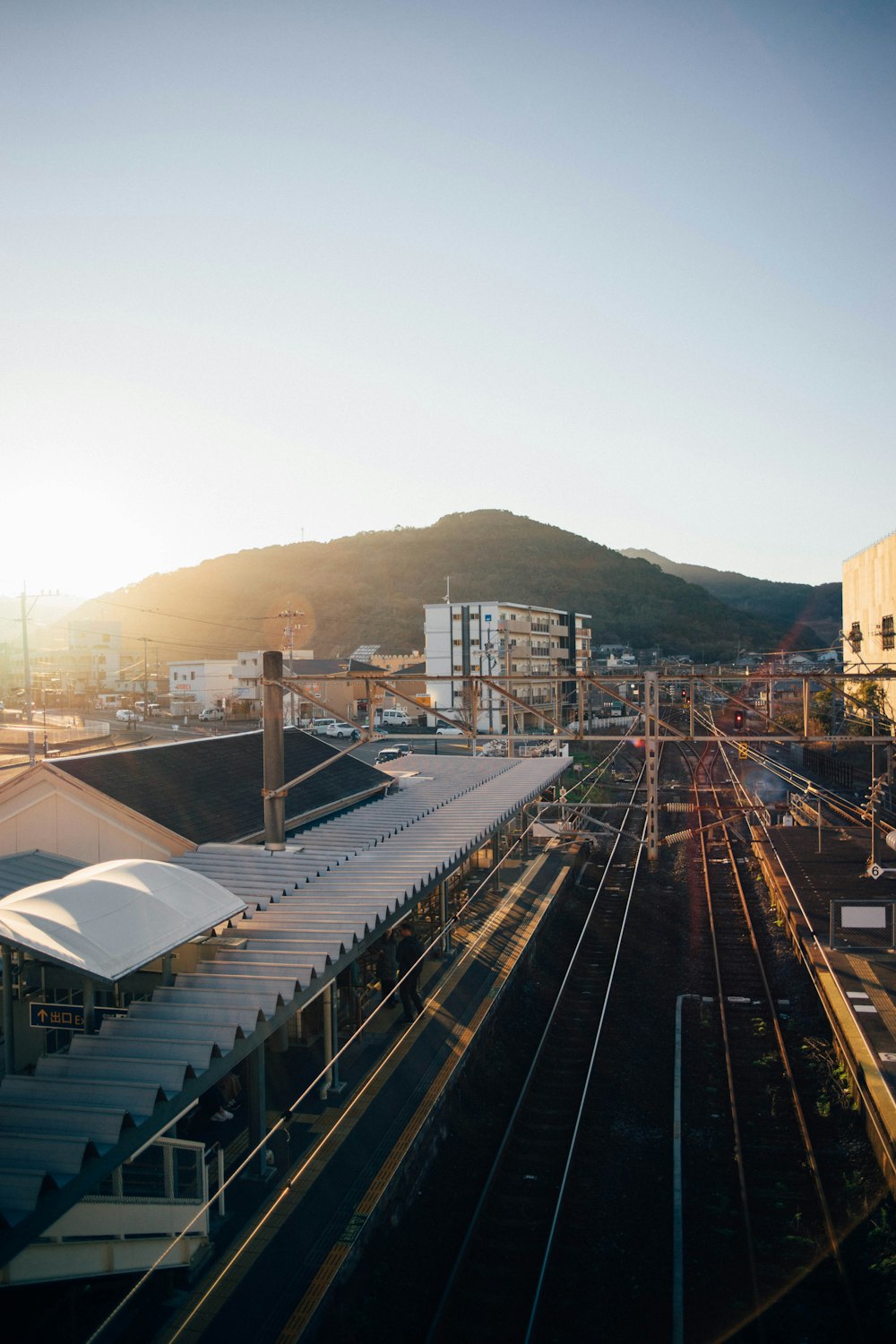 a view of a train station with a mountain in the background