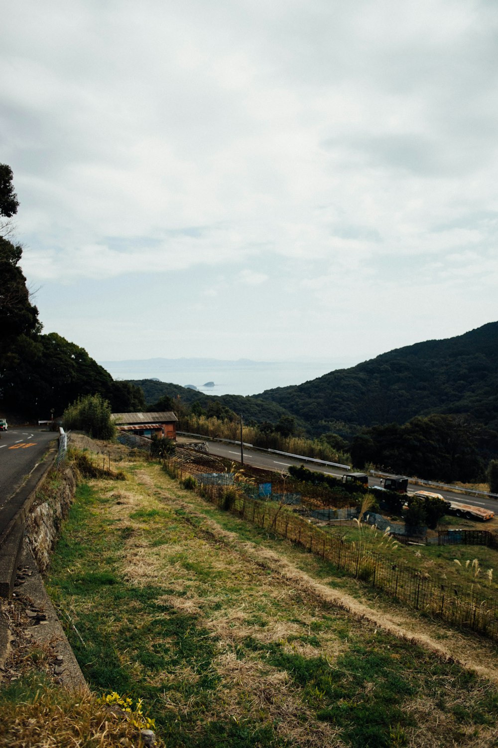 a view of a road with a hill in the background