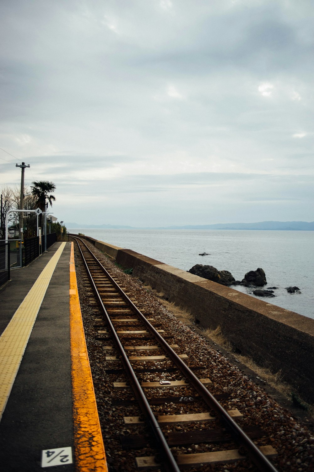 a train track next to a body of water