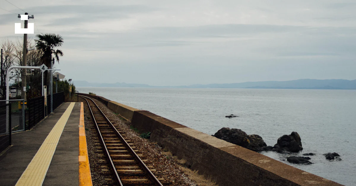 Chiwata A train track next to a body of water photo – Free Chiwata station ...