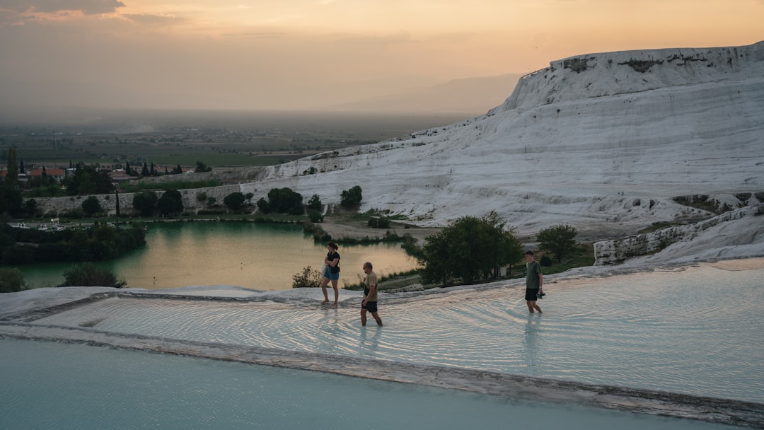 a group of people standing in a pool of water,