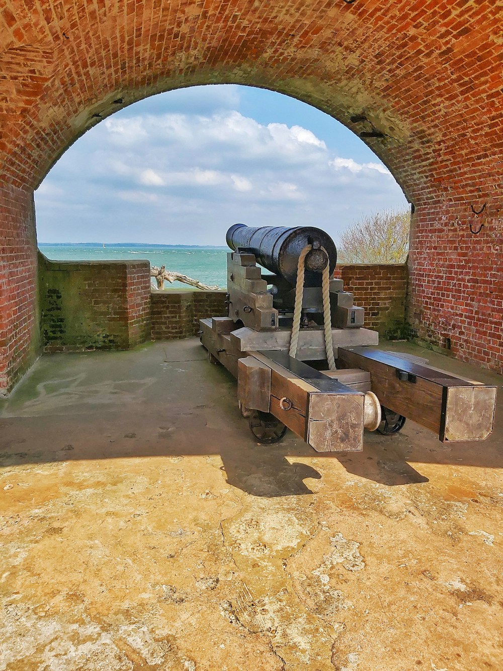 a cannon sitting in the middle of a tunnel