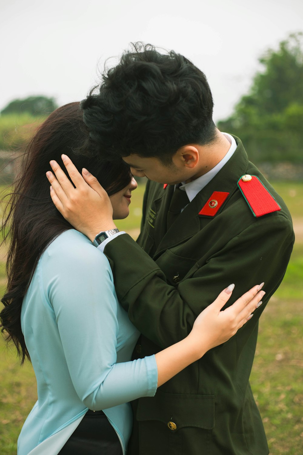 a man and a woman hugging in a field