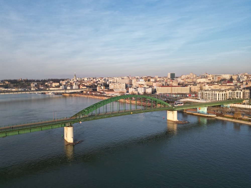 a bridge over a body of water with a city in the background