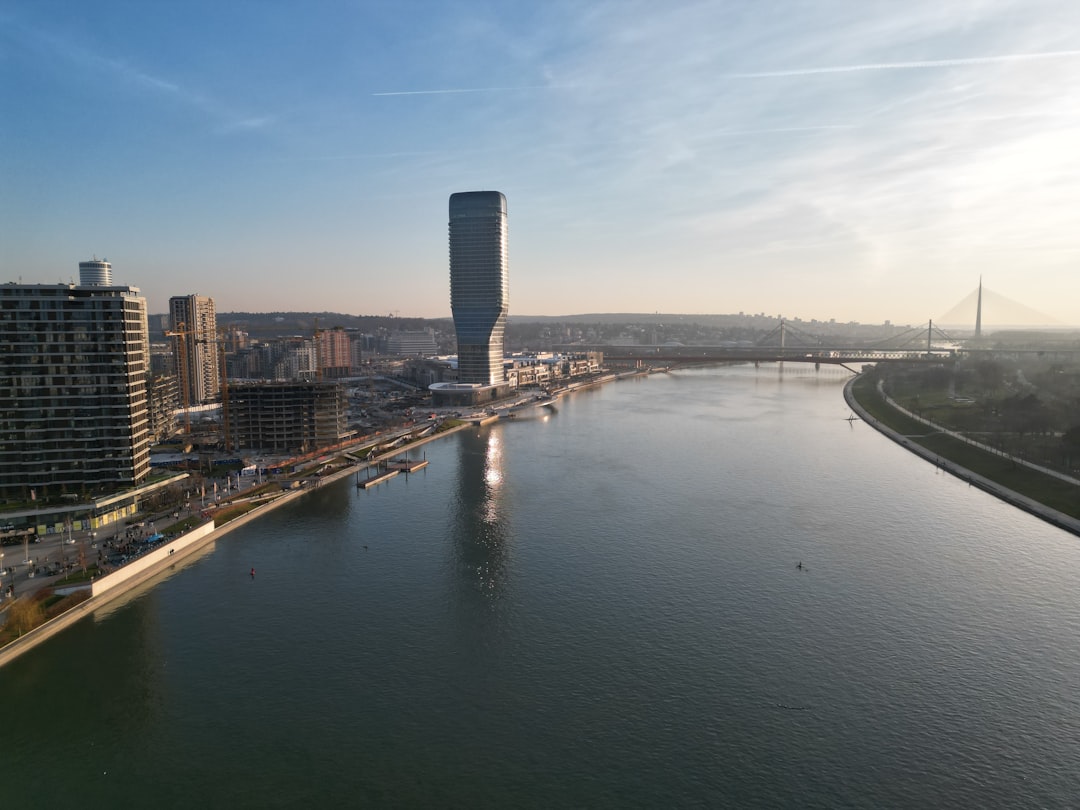 a river running through a city next to tall buildings,