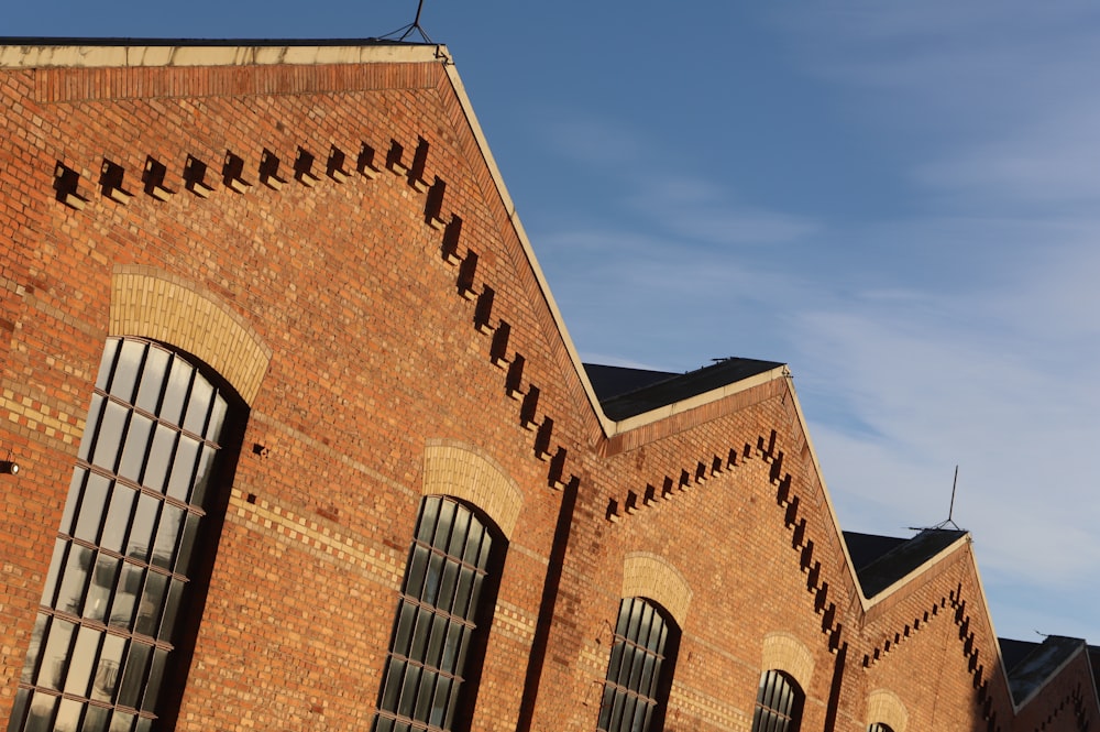 a brick building with windows and a clock tower