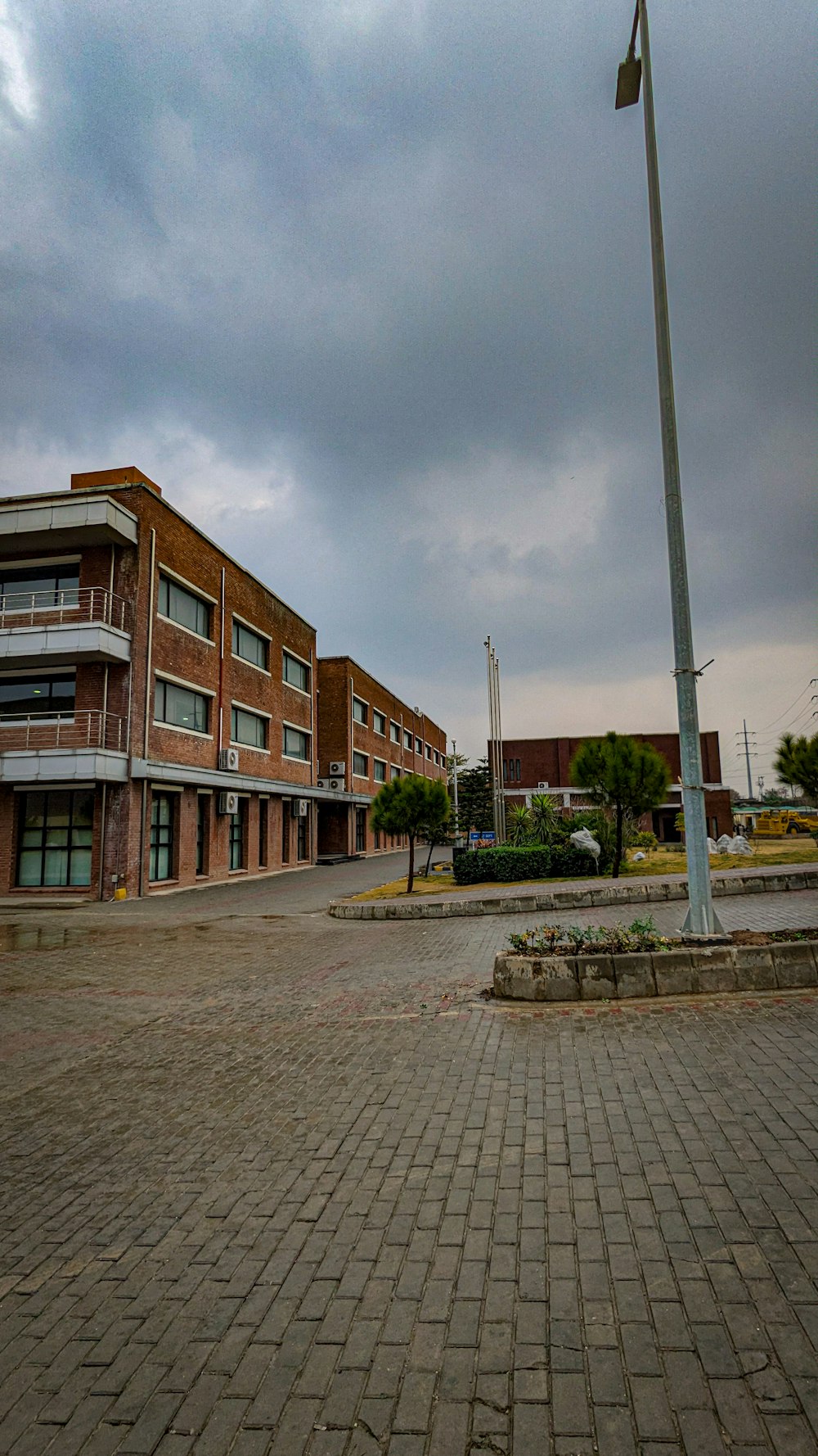 a clock on a pole in front of a building