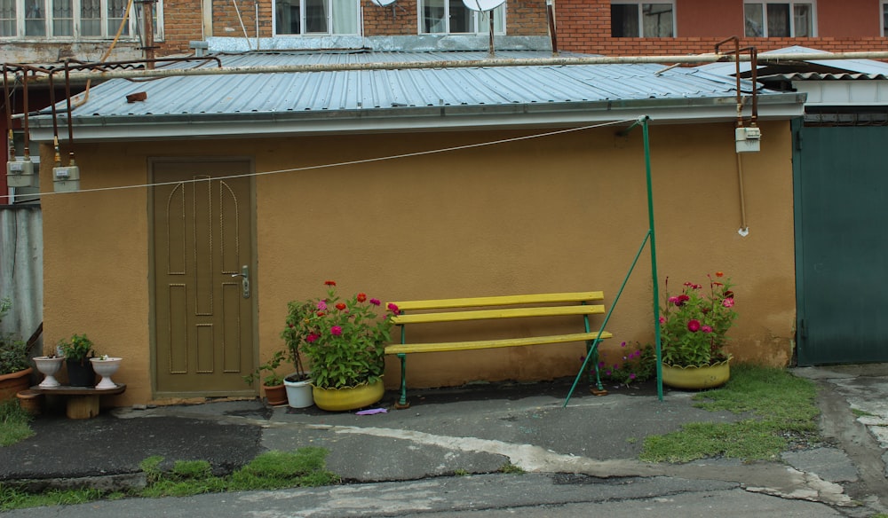 a yellow bench sitting in front of a building