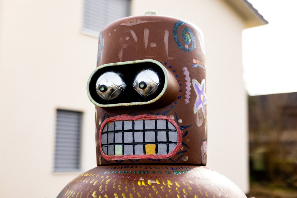 a close up of a fire hydrant with a face painted on it