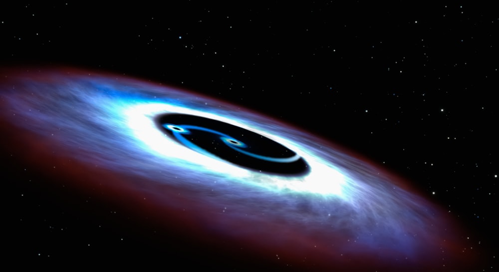 a black hole with a blue disk in the middle of it