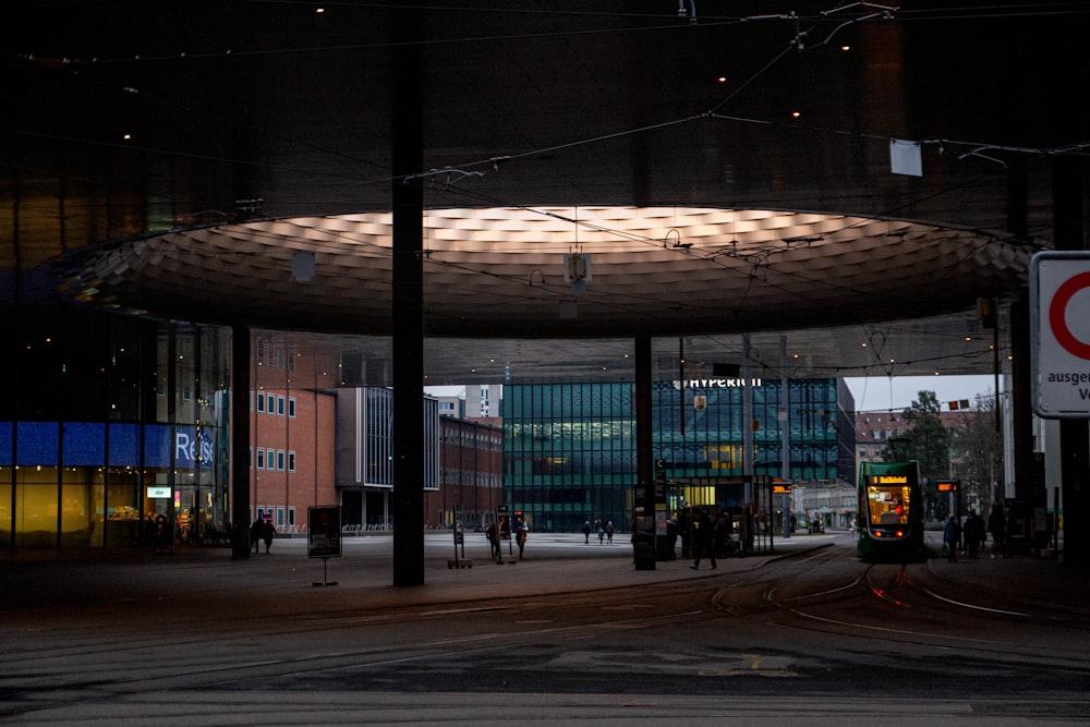 a city street at night with people walking around