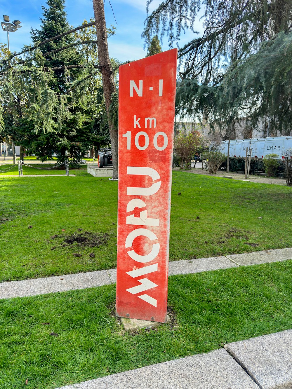 a red sign sitting on the side of a road