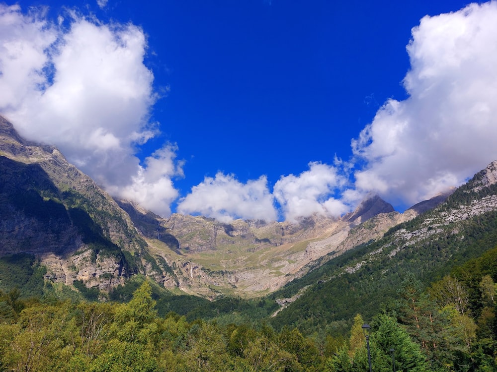 a view of a mountain range with clouds in the sky