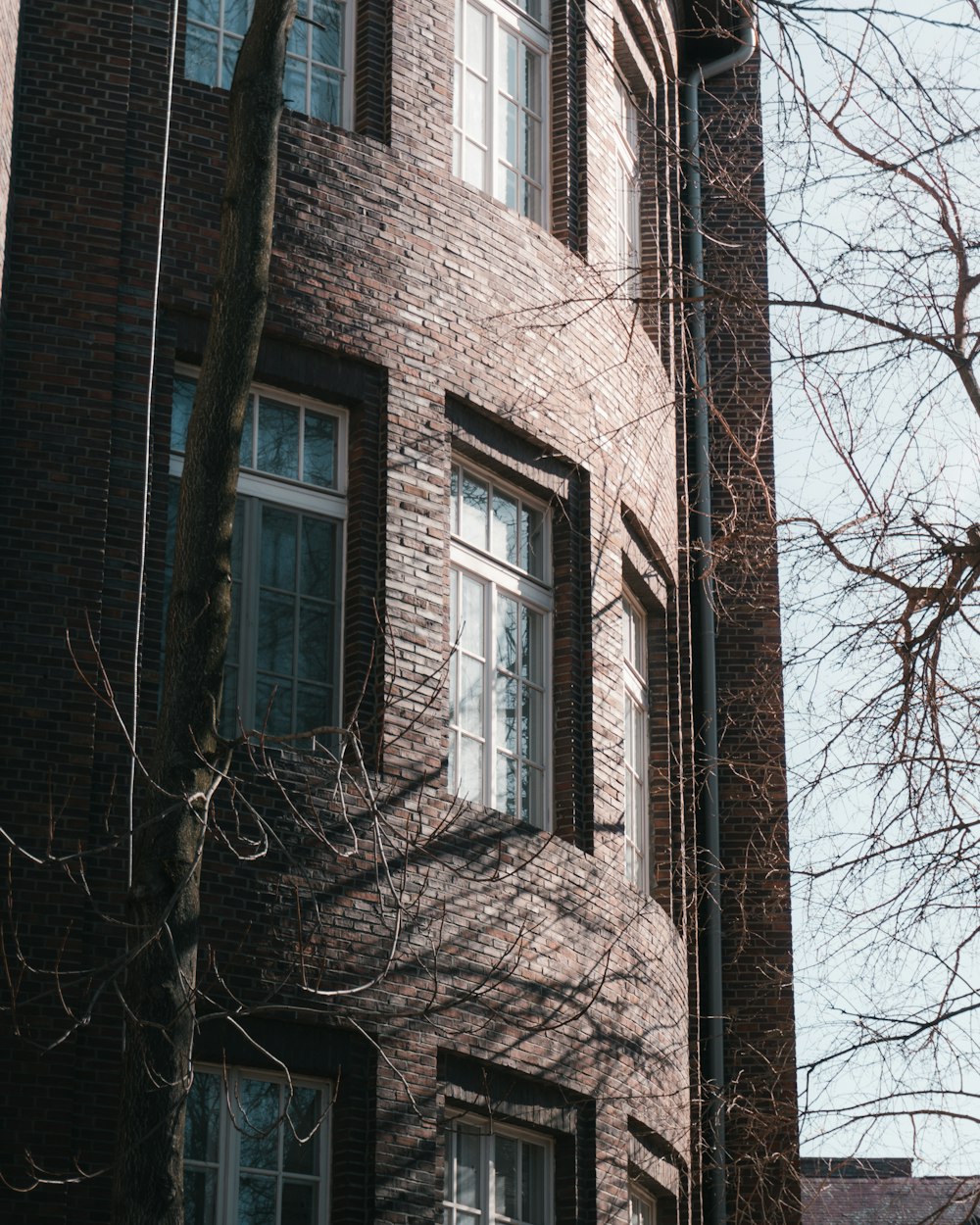 a tall brick building with a clock on the front of it