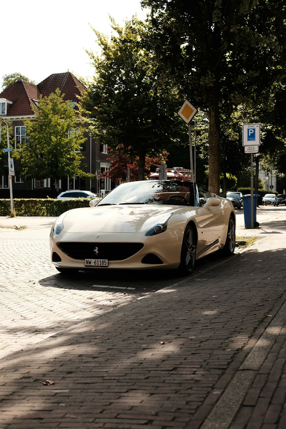 a white sports car parked on the side of the road