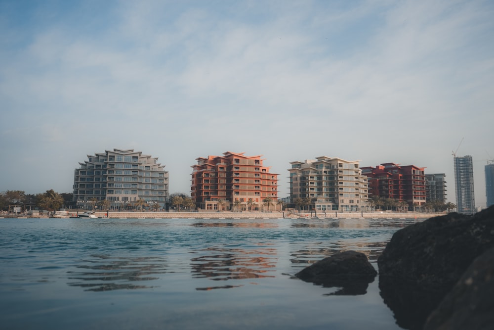 a body of water with buildings in the background