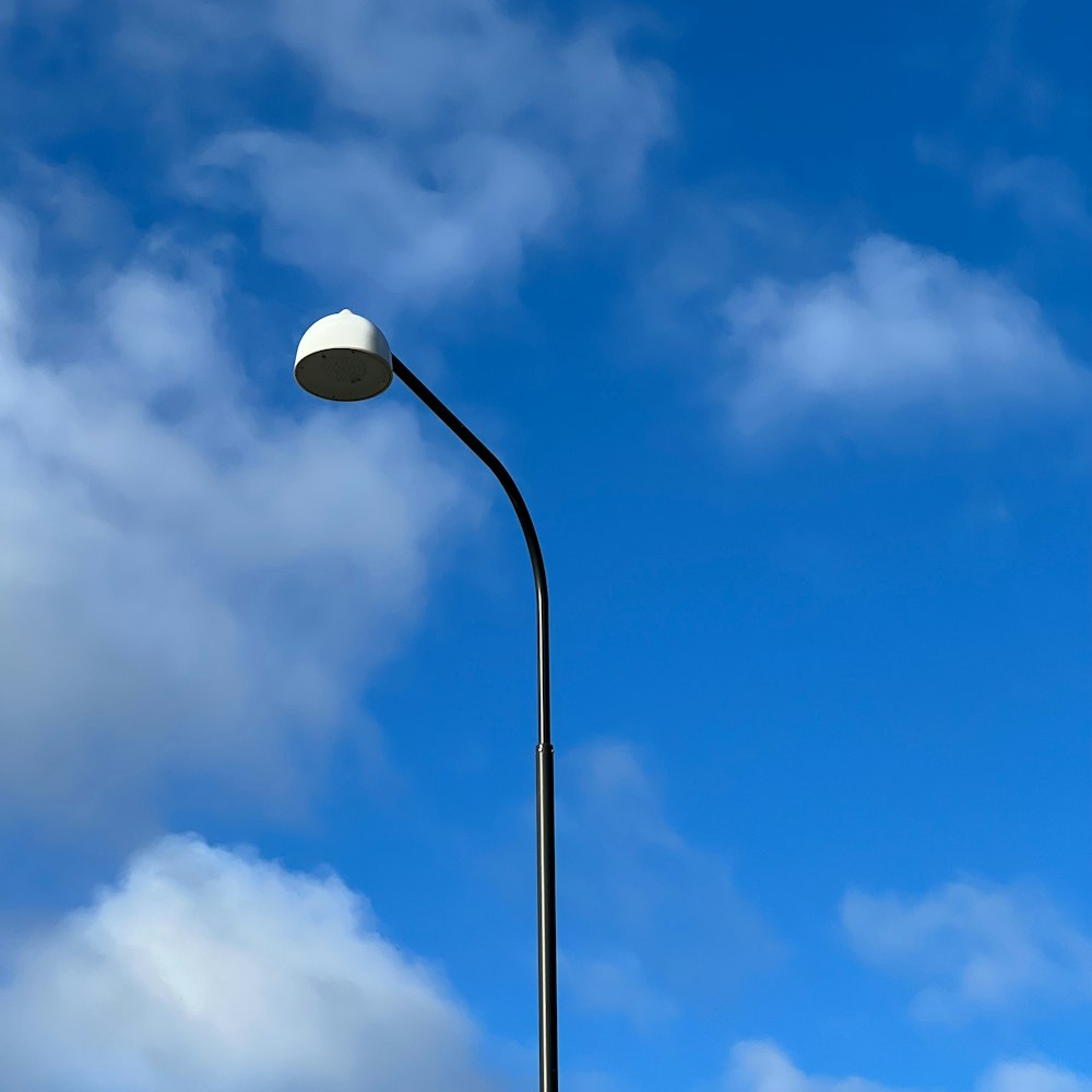 a street light with a blue sky in the background