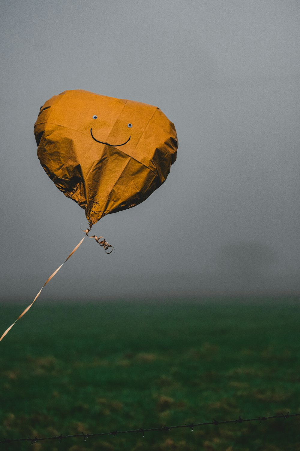 a yellow kite with a smiley face on it