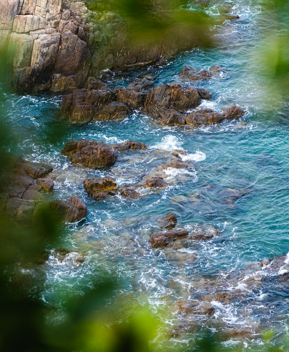 a view of a body of water with rocks in the foreground