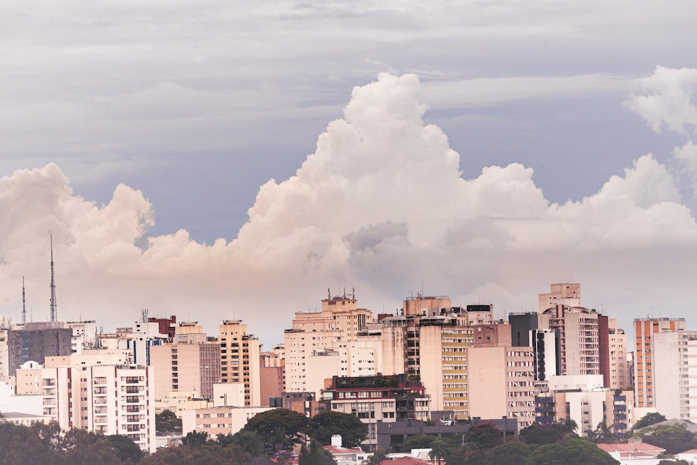 a view of a city skyline with clouds in the sky