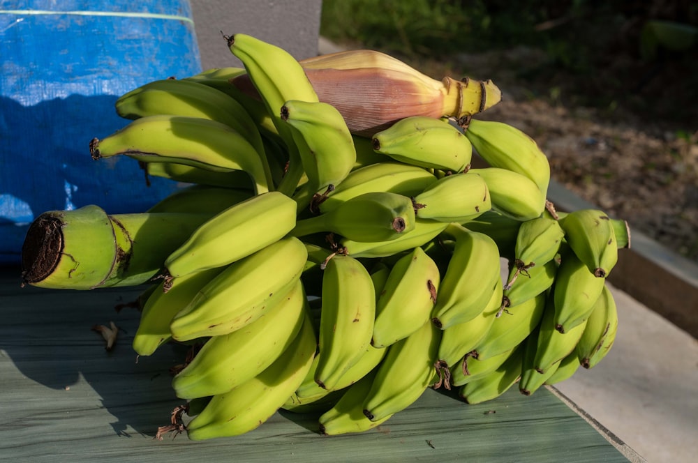 a bunch of bananas sitting on top of a wooden table