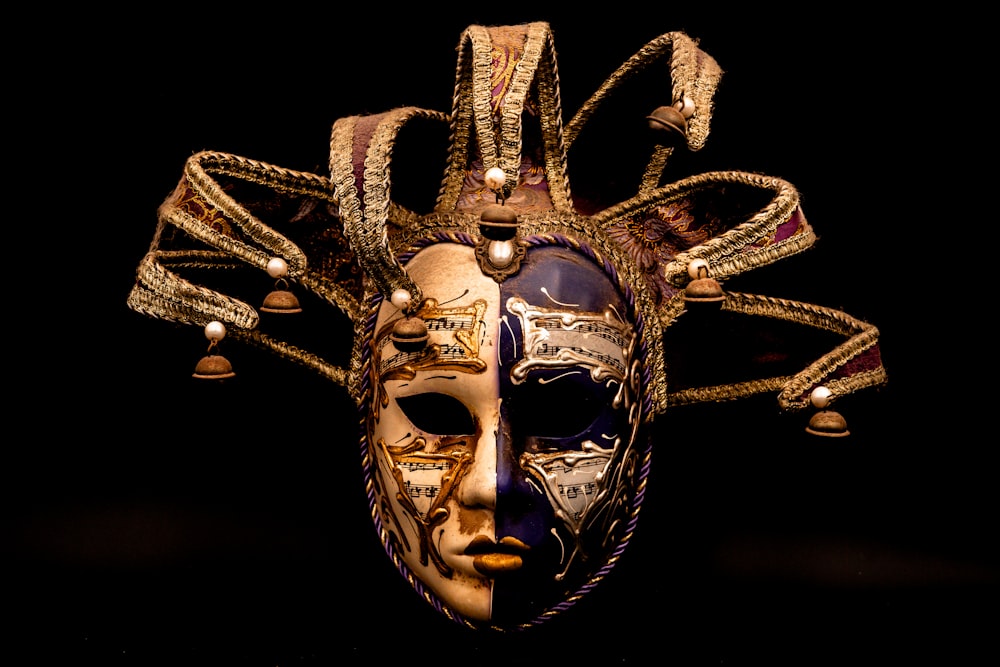 a masquerade mask is adorned with jewels and beads