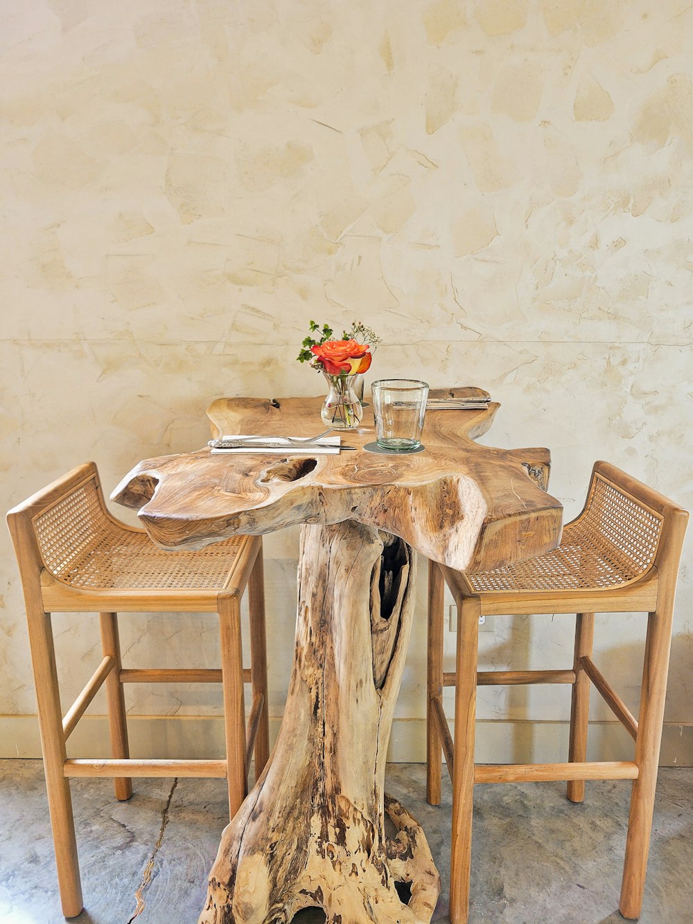 a wooden table with two chairs around it