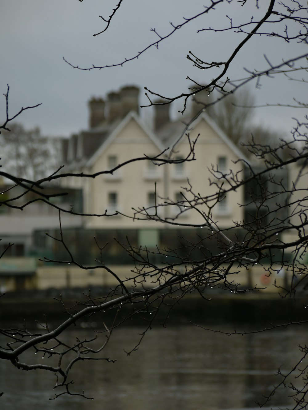 a white house sitting next to a body of water