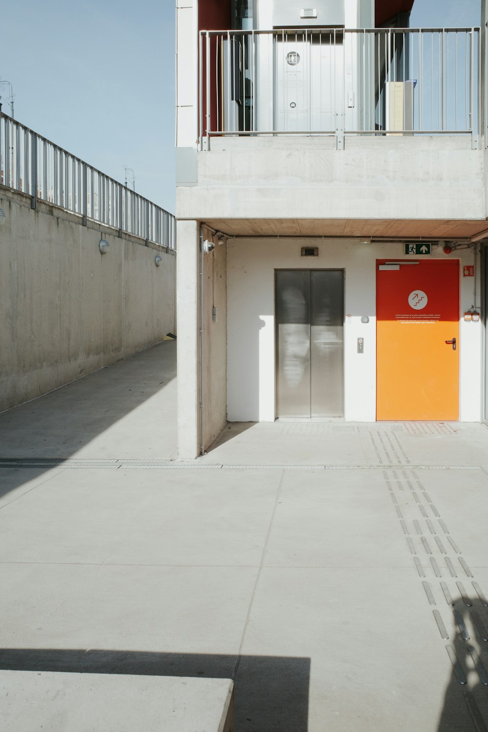 a white building with a red door and a yellow door