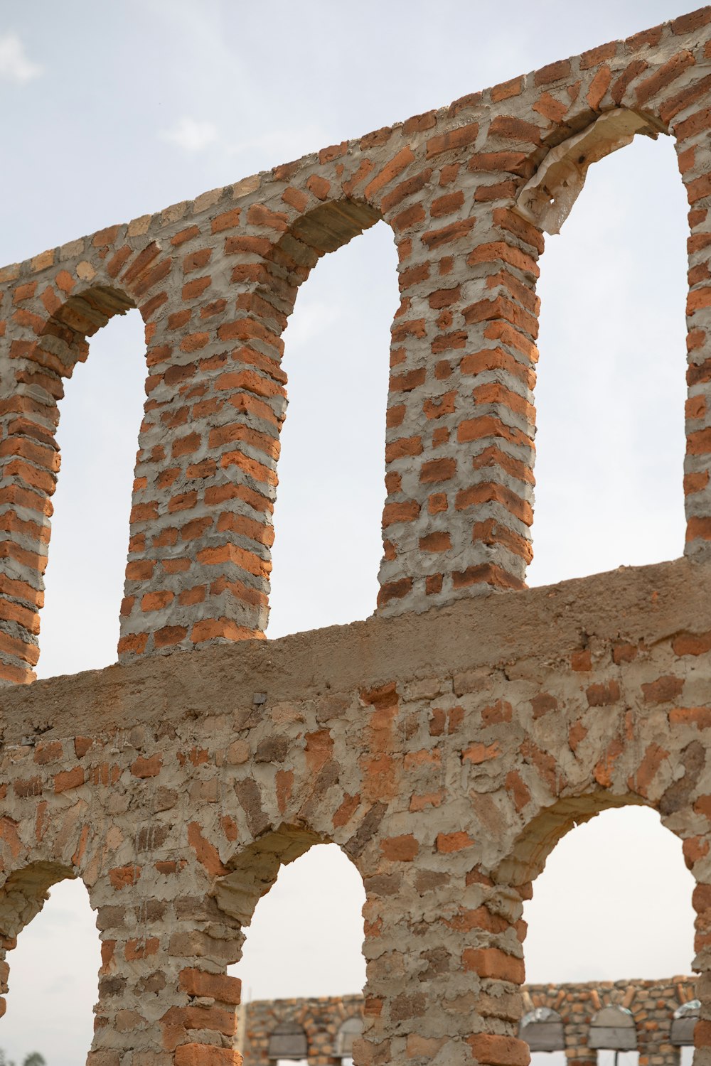 an old brick wall with arches and arches