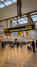 a group of people walking through an airport