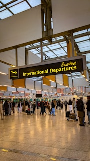 a group of people walking through an airport