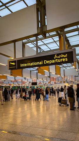 a group of people walking through an airport