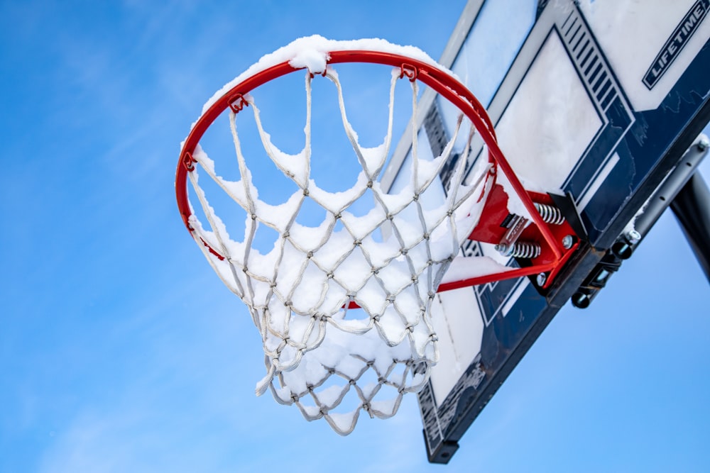 a basketball going through the net in the snow