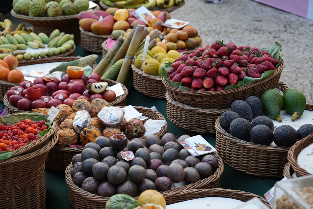 a table topped with baskets filled with lots of fruit